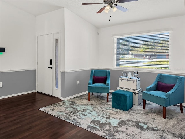 sitting room with baseboards, a ceiling fan, and wood finished floors