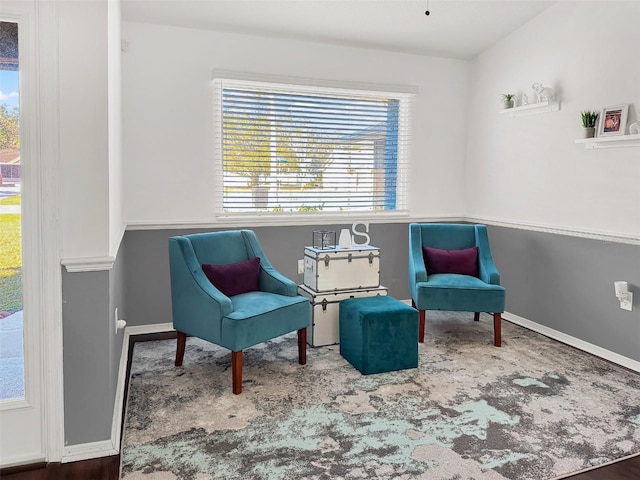 living area with plenty of natural light and baseboards