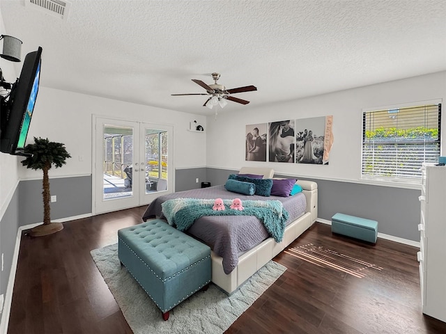 bedroom with access to outside, multiple windows, french doors, and wood finished floors