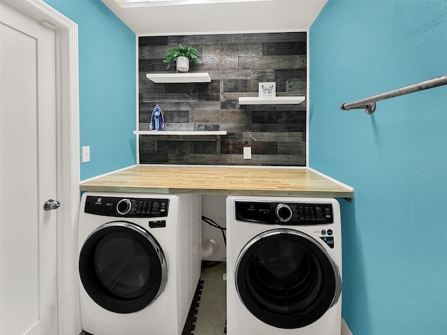 laundry room featuring tile patterned floors, laundry area, and washing machine and clothes dryer