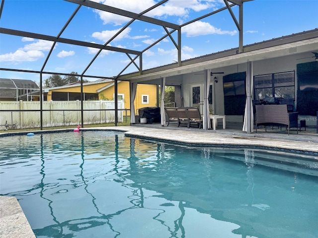 view of swimming pool featuring glass enclosure, a fenced in pool, and a patio area