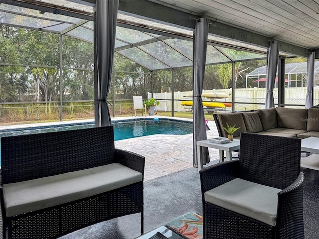 view of swimming pool featuring a lanai, a fenced in pool, a fenced backyard, a patio, and outdoor lounge area