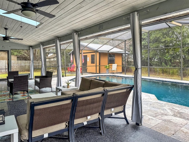 view of pool with ceiling fan, a patio, an outdoor living space, a fenced in pool, and glass enclosure