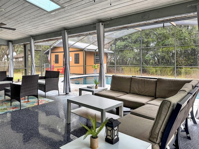 sunroom with ceiling fan, a skylight, and an outdoor hangout area