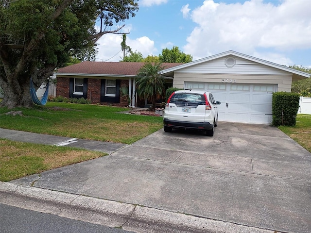 3231 Lowndes Dr, Winter Park, FL 32792 - single story home featuring concrete driveway, a front yard, and an attached garage