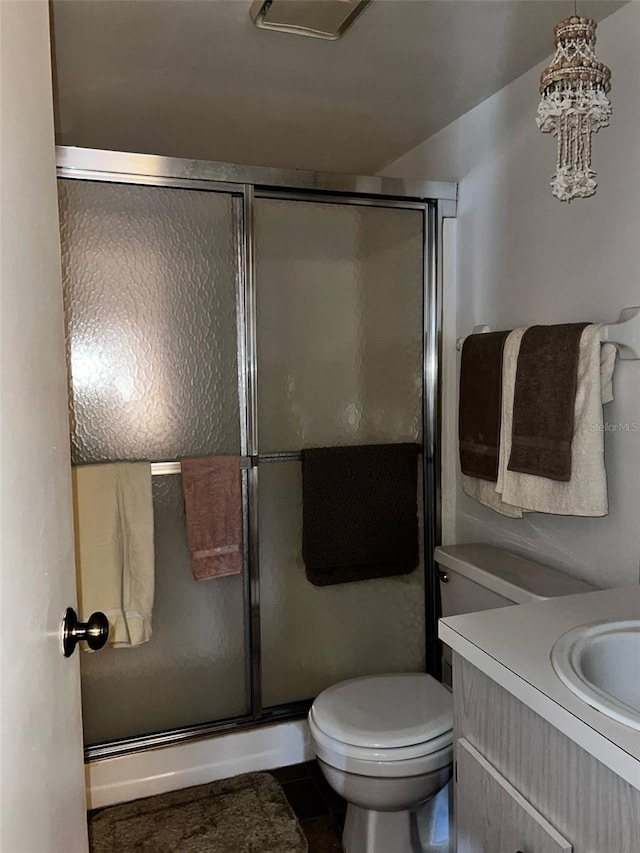 2659 Crown Ct Unit 11, Kissimmee, FL 34741 - bathroom featuring toilet, vanity, tile patterned flooring, and a shower with door