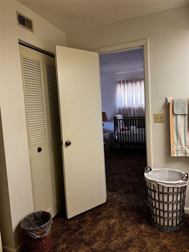 2659 Crown Ct Unit 11, Kissimmee, FL 34741 - hall featuring a textured ceiling, visible vents, and carpet flooring