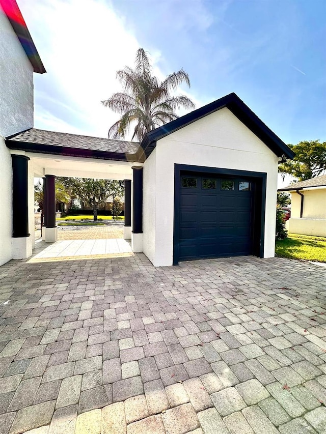 garage with decorative driveway