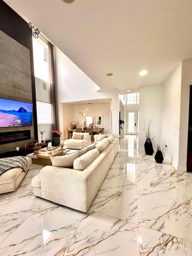 living room featuring baseboards, recessed lighting, and marble finish floor