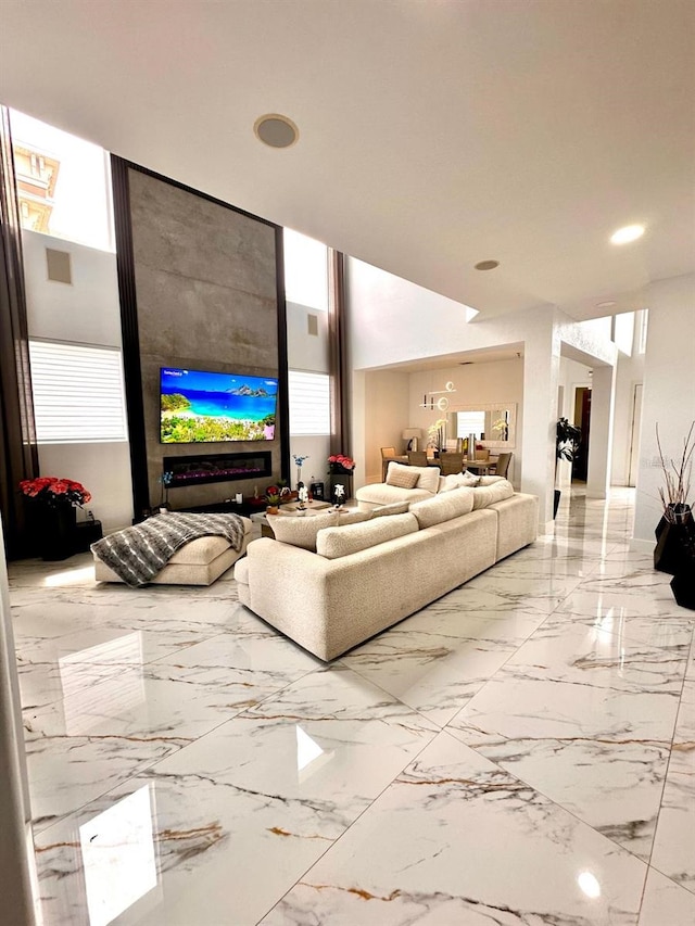 living room with visible vents, recessed lighting, and marble finish floor