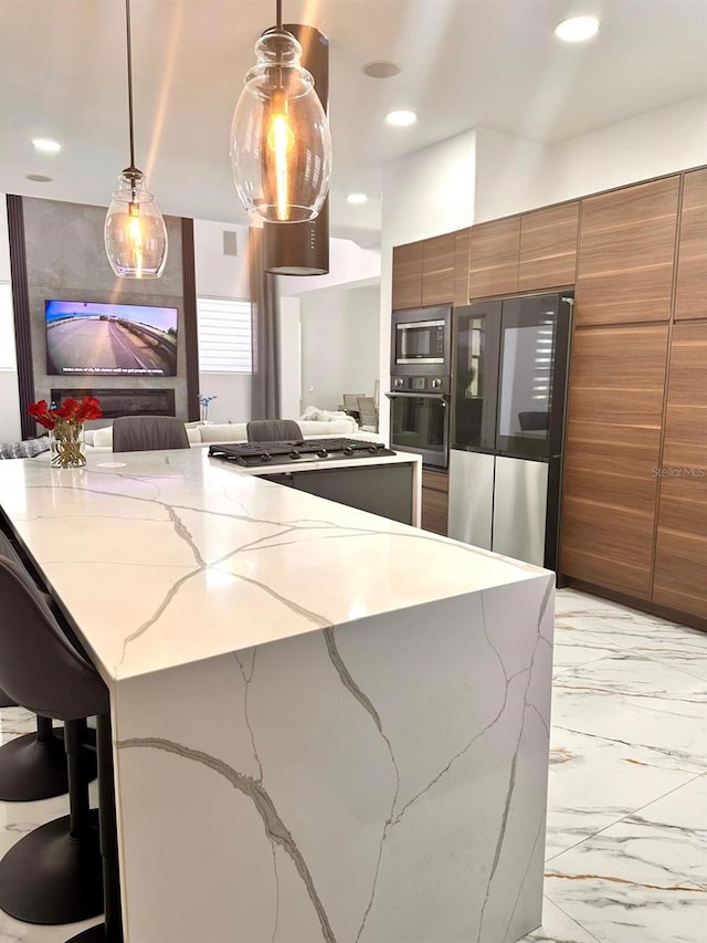 kitchen with modern cabinets, stainless steel appliances, brown cabinetry, marble finish floor, and light stone counters