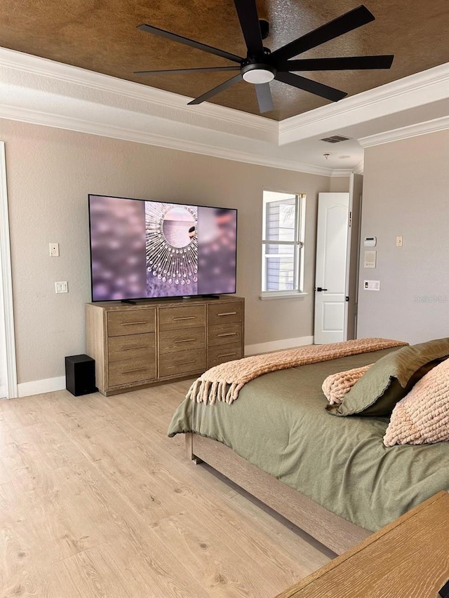 bedroom featuring visible vents, ceiling fan, baseboards, light wood finished floors, and ornamental molding