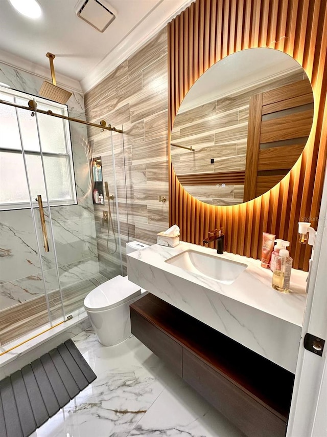 full bathroom featuring marble finish floor, toilet, vanity, a marble finish shower, and crown molding