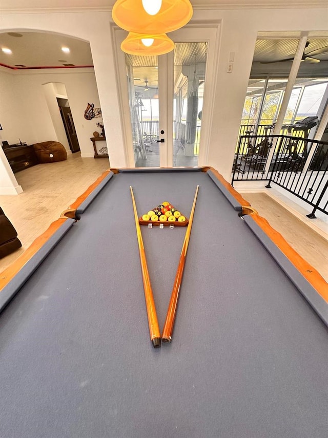 recreation room with crown molding, arched walkways, and pool table