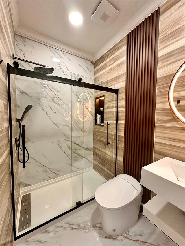 bathroom featuring a marble finish shower, marble finish floor, and toilet