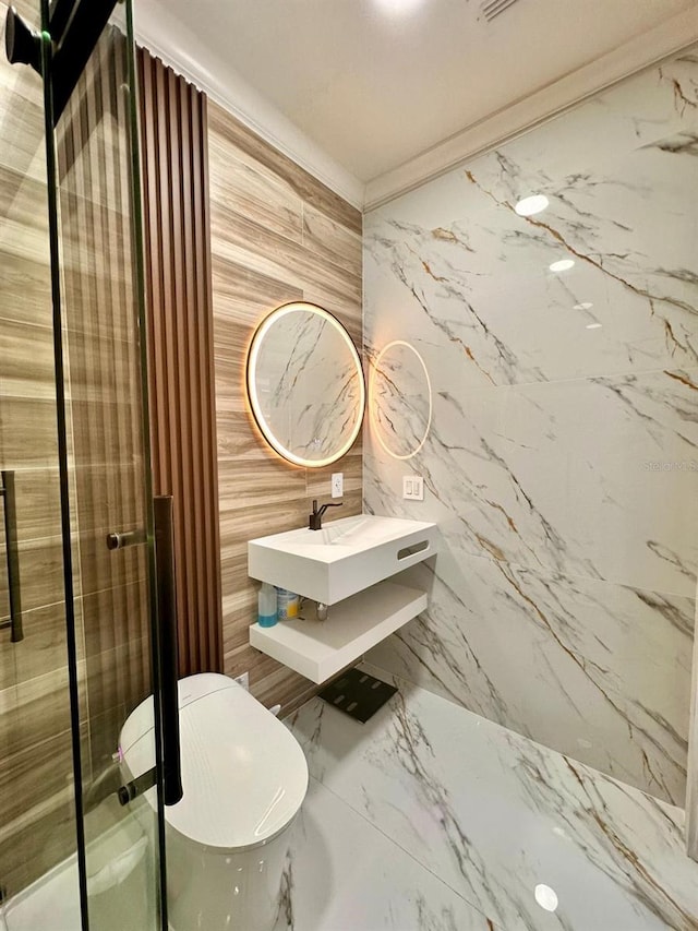 bathroom with marble finish floor and a sink