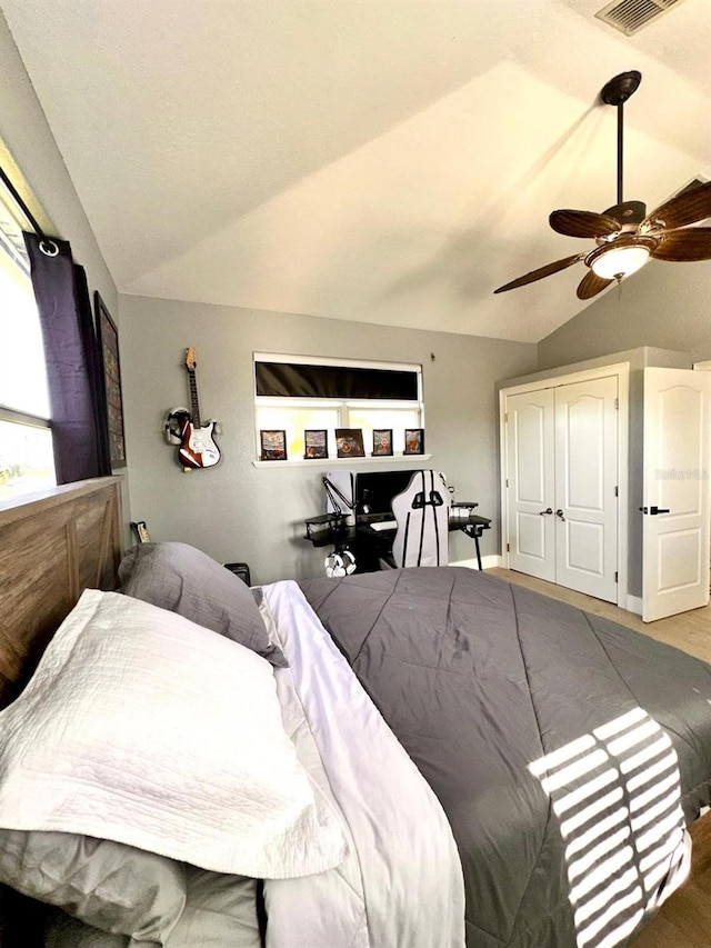 bedroom with visible vents, wood finished floors, ceiling fan, and vaulted ceiling