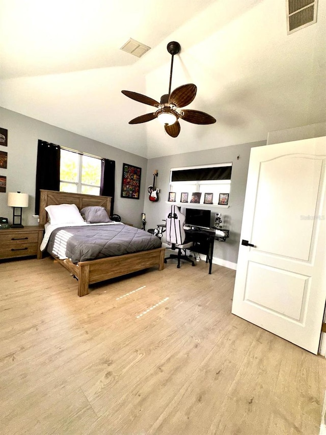 bedroom featuring visible vents, ceiling fan, wood finished floors, and lofted ceiling