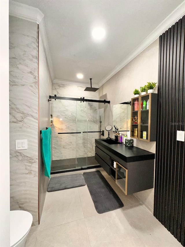 bathroom with tile patterned flooring, a shower stall, tile walls, toilet, and crown molding