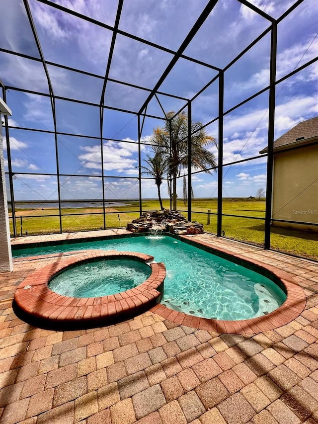 view of pool with a lanai, a patio area, and a pool with connected hot tub