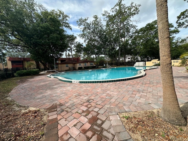 pool featuring a patio and fence