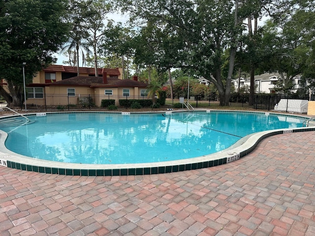 community pool featuring fence