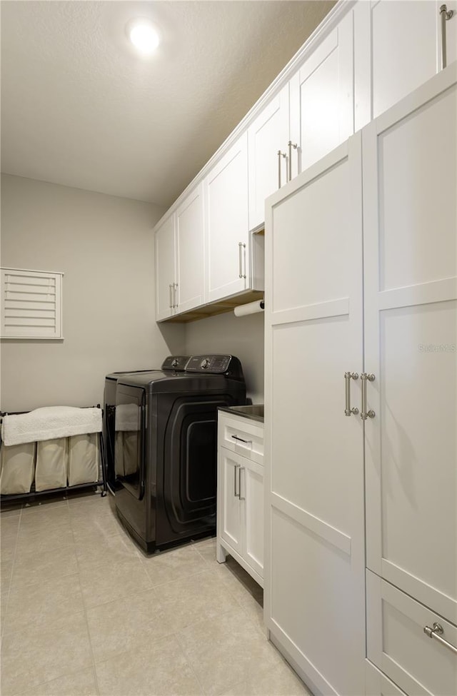 15079 Guava Bay Dr, Winter Garden, FL 34787 - laundry area with separate washer and dryer, cabinet space, and light tile patterned floors