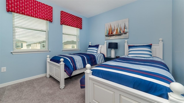 bedroom featuring light colored carpet and baseboards