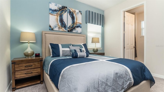bedroom featuring carpet floors and baseboards