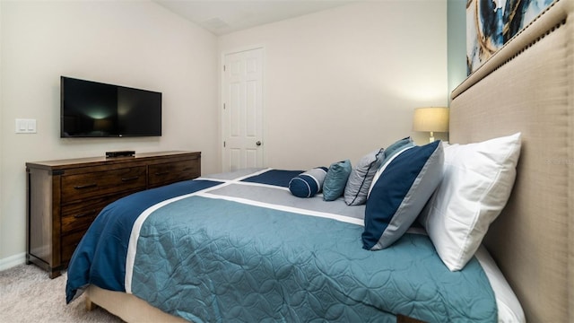 bedroom with carpet and baseboards