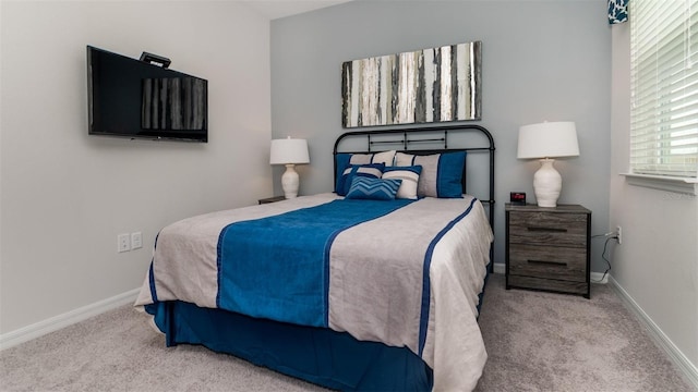 carpeted bedroom featuring baseboards