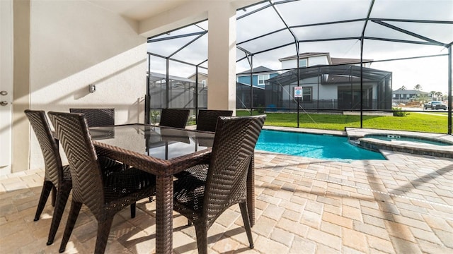 view of pool with a patio area, a yard, glass enclosure, and a pool with connected hot tub
