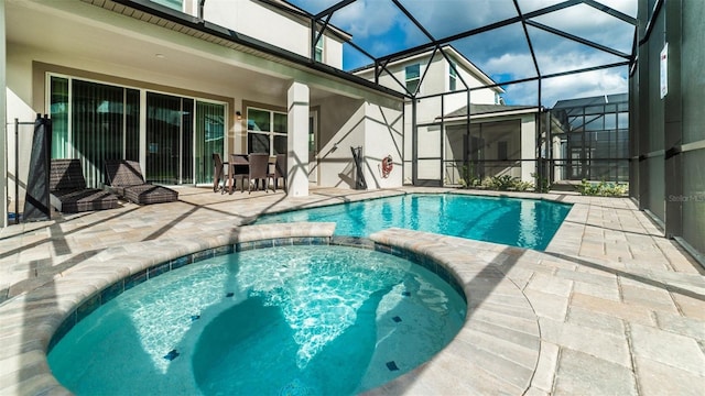 view of pool featuring a patio, a pool with connected hot tub, and a lanai