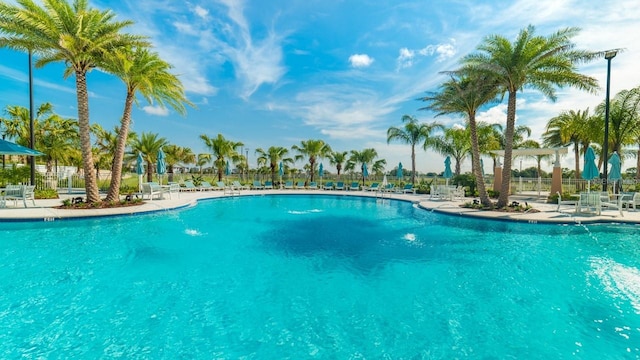 pool with fence and a patio