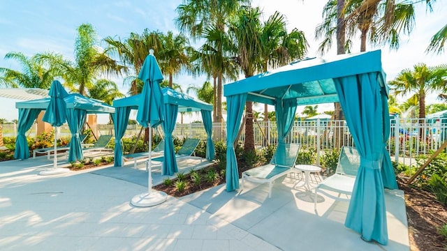 view of play area with a gazebo, a patio area, and fence