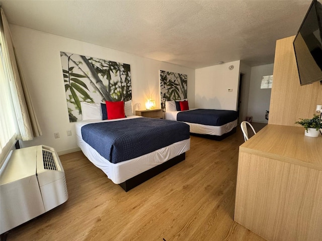 5245 W Irlo Bronson Memorial Hwy Unit 210, Kissimmee, FL 34746 - bedroom featuring a textured ceiling and wood finished floors