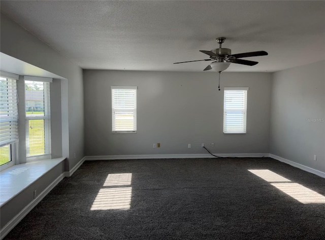 spare room with ceiling fan, plenty of natural light, baseboards, and dark carpet