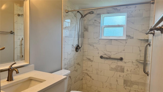 bathroom with a stall shower, vanity, and toilet