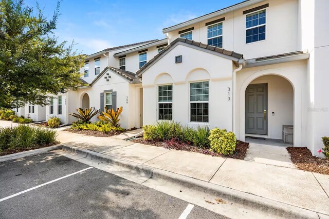 313 Captiva Dr, Davenport, FL 33896 - view of front facade featuring stucco siding and uncovered parking