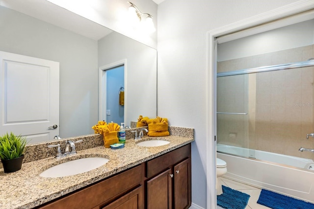 313 Captiva Dr, Davenport, FL 33896 - bathroom with double vanity, toilet, tile patterned floors, and combined bath / shower with glass door
