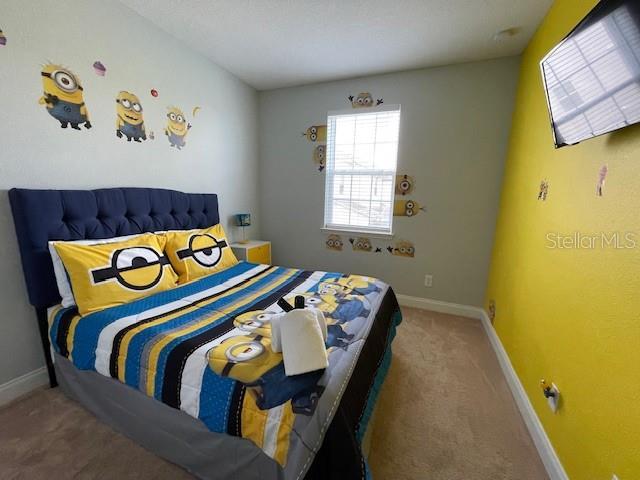 313 Captiva Dr, Davenport, FL 33896 - carpeted bedroom featuring baseboards