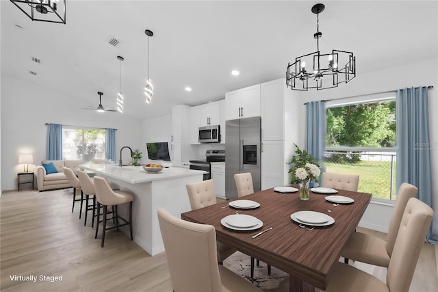 108 Pearlwood St, Orlando, FL 32811 - dining space with a chandelier, vaulted ceiling, light wood finished floors, recessed lighting, and ceiling fan