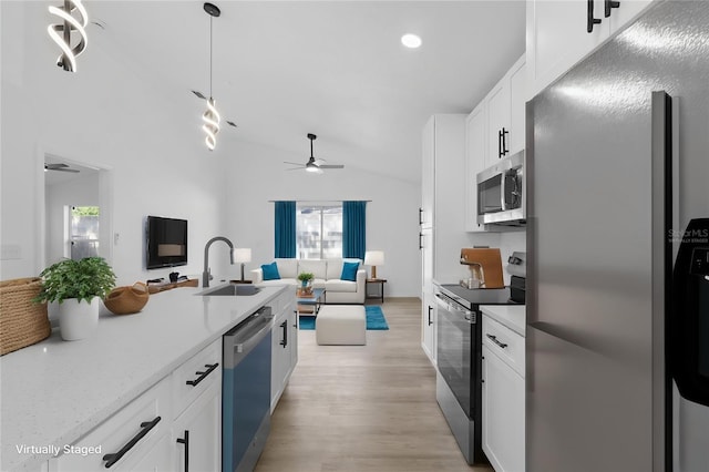 108 Pearlwood St, Orlando, FL 32811 - kitchen featuring stainless steel appliances, a sink, lofted ceiling, open floor plan, and ceiling fan