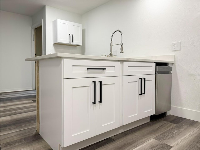1799 N Highland Ave Unit 143, Clearwater, FL 33755 - bar featuring baseboards, stainless steel dishwasher, dark wood-type flooring, and a sink