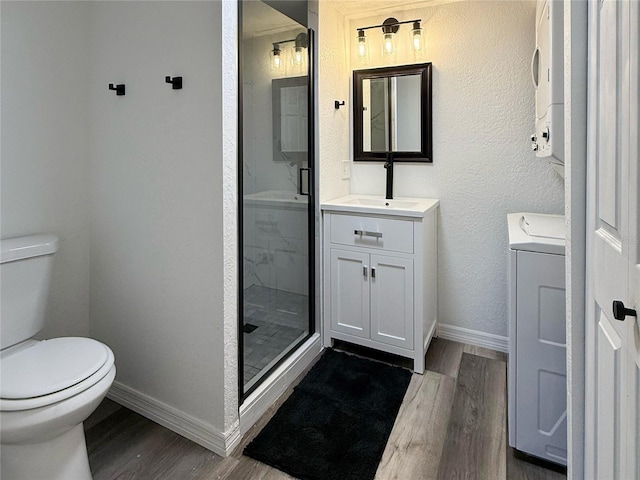 1799 N Highland Ave Unit 143, Clearwater, FL 33755 - bathroom with vanity, washer and dryer, wood finished floors, and baseboards