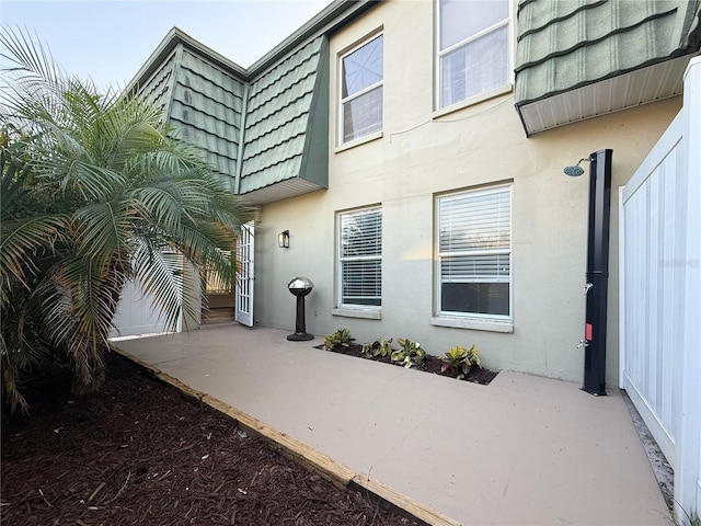 1799 N Highland Ave Unit 143, Clearwater, FL 33755 - back of property with stucco siding, a patio area, and mansard roof