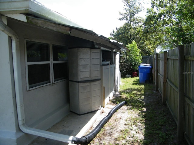 view of side of home featuring fence