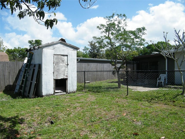 exterior space with a storage unit, an outdoor structure, and a fenced backyard