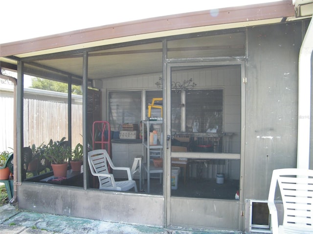 entrance to property featuring fence