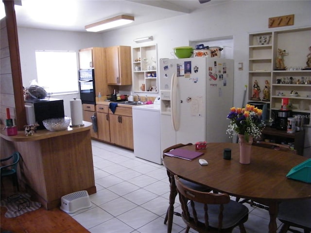 kitchen featuring light tile patterned floors, open shelves, washer / dryer, white fridge with ice dispenser, and black oven